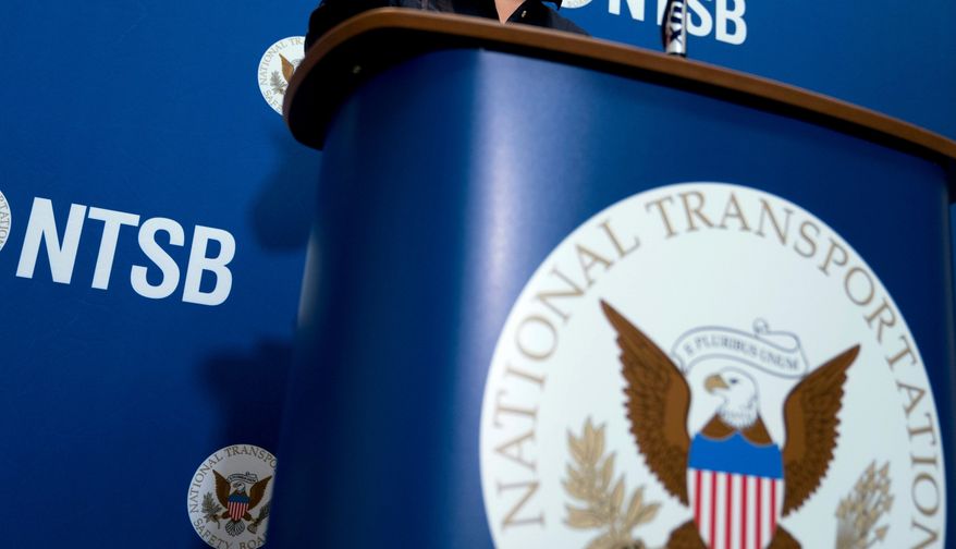 The National Transportation Safety Board logo and signage are seen at a news conference at NTSB headquarters in Washington, Dec. 18, 2017. (AP Photo/Andrew Harnik, File)