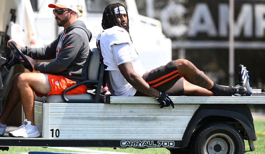 Cleveland Browns defensive end Alex Wright, right, is carted off the field with an apparent leg injury during a joint NFL football practice with the Buffalo Bills in Berea, Ohio, Thursday, Aug. 20, 2026. (AP Photo/David Richard)