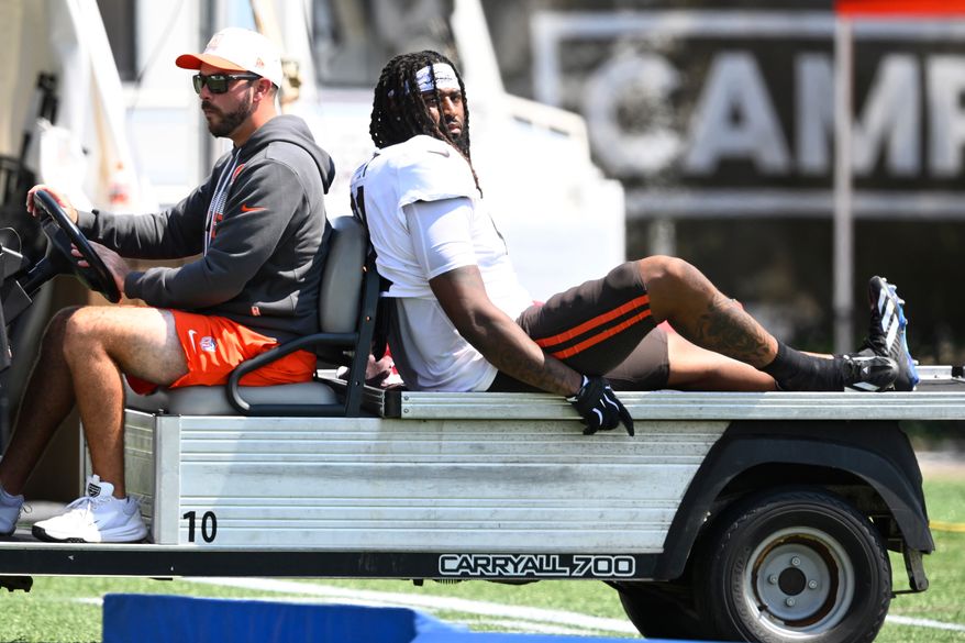 Cleveland Browns defensive end Alex Wright, right, is carted off the field with an apparent leg injury during a joint NFL football practice with the Buffalo Bills in Berea, Ohio, Thursday, Aug. 20, 2026. (AP Photo/David Richard)