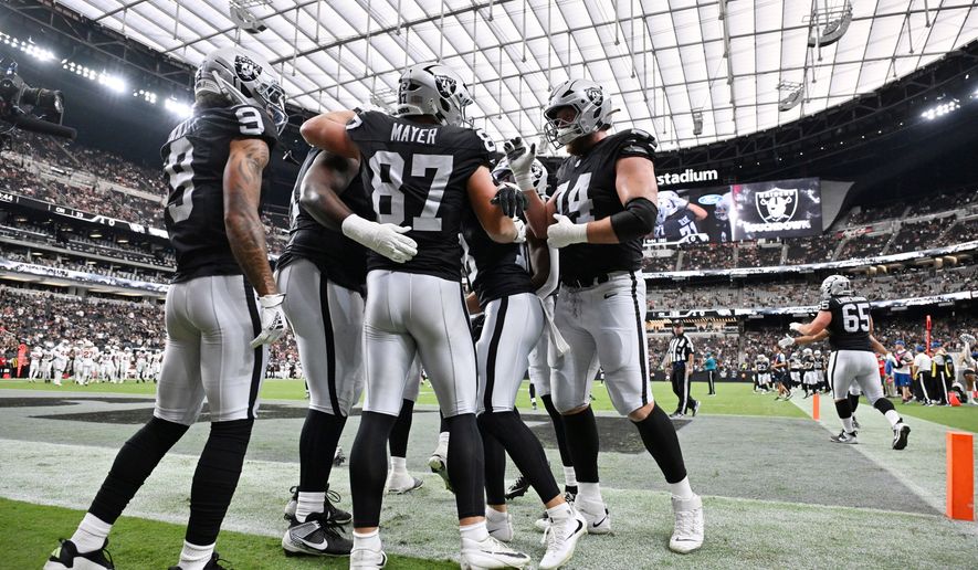 Las Vegas Raiders tight end Michael Mayer (87) celebrates his toucdown against the Arizona Cardinals with teammates, including wide receiver Jalen Nailor (9) and offensive tackle Kolton Miller (74), during the first half of a preseason NFL football game, Thursday, Aug. 13, 2026, in Las Vegas. (AP Photo/David Becker)