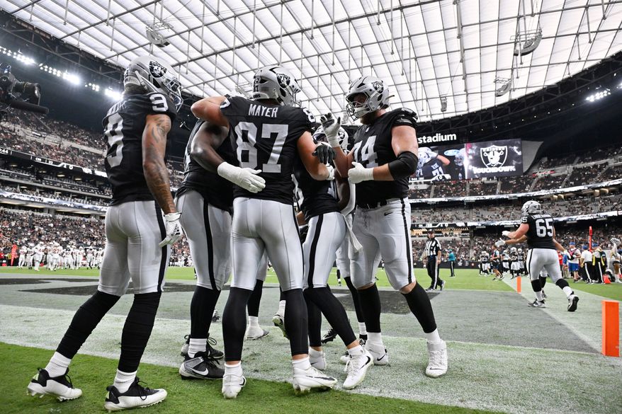 Las Vegas Raiders tight end Michael Mayer (87) celebrates his toucdown against the Arizona Cardinals with teammates, including wide receiver Jalen Nailor (9) and offensive tackle Kolton Miller (74), during the first half of a preseason NFL football game, Thursday, Aug. 13, 2026, in Las Vegas. (AP Photo/David Becker)