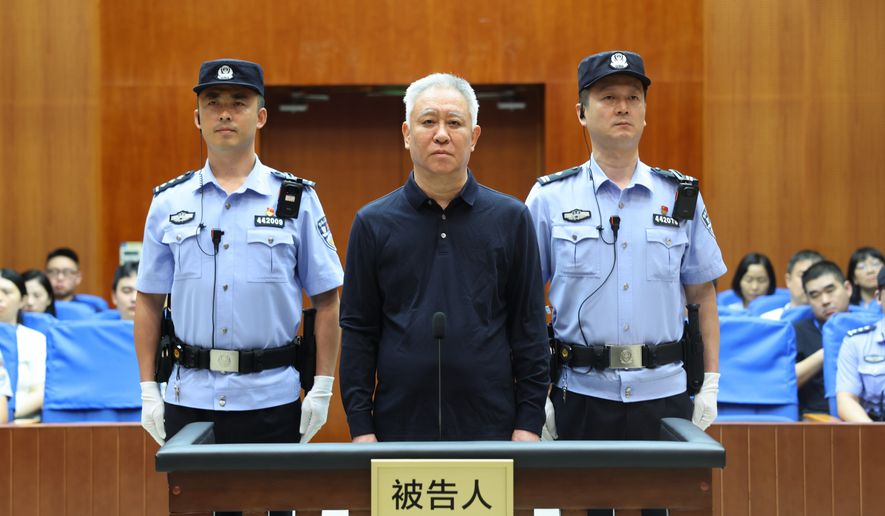 In this handout photo released by Xinhua News Agency, Hui Ka Yan, also known as Xu Jiayin, founder of property developer Evergrande, stands trial at the Shenzhen Intermediate People's Court in Shenzhen, south China's Guangdong Province, Thursday, Aug. 20, 2026. (Shenzhen Intermediate People's Court/Xinhua via AP)