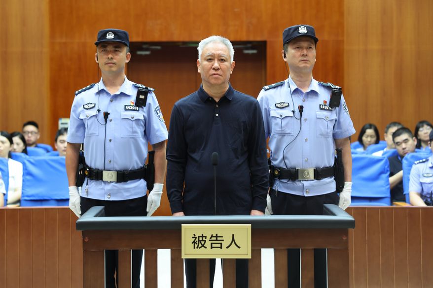 In this handout photo released by Xinhua News Agency, Hui Ka Yan, also known as Xu Jiayin, founder of property developer Evergrande, stands trial at the Shenzhen Intermediate People's Court in Shenzhen, south China's Guangdong Province, Thursday, Aug. 20, 2026. (Shenzhen Intermediate People's Court/Xinhua via AP)