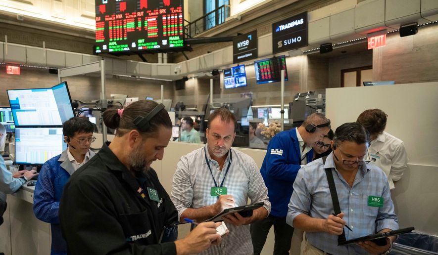 Options traders Chris Dattolo, Scott Frinzi, and Ravi Bhandari, left to right, work on the floor of the New York Stock Exchange, Monday, Aug. 17, 2026, in New York. (AP Photo/Yuki Iwamura)