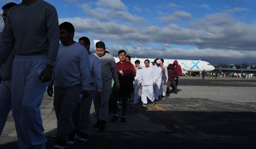 FILE - Guatemalans deported from the U.S. arrive at La Aurora airport in Guatemala City, Dec. 30, 2025, after deplaning a repatriation flight. (AP Photo/Moises Castillo, File)