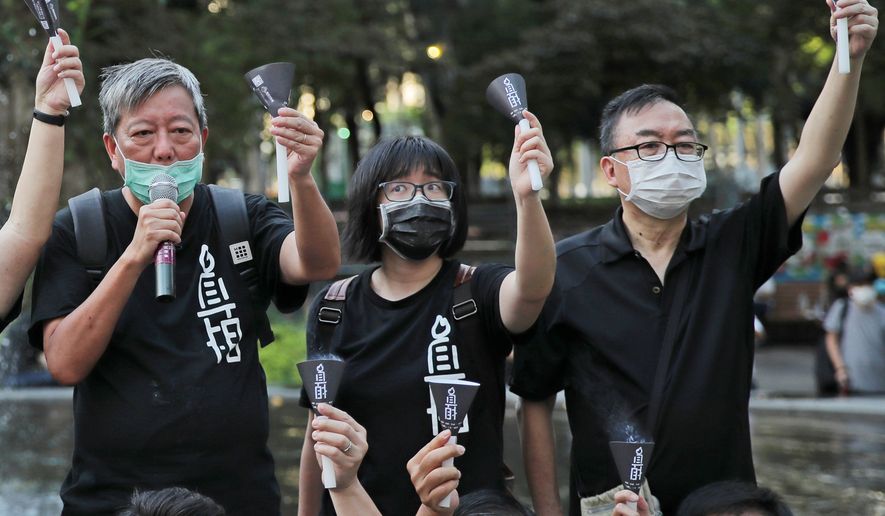 FILE - Fom left, pro-democracy activists Lee Cheuk-yan, Chow Hang-tung, and Cheung Man-kwong attend a gathering to mourn for those killed in the 1989 Tiananmen crackdown at Victoria Park, in Hong Kong on June 4, 2020. (AP Photo/Kin Cheung, File)