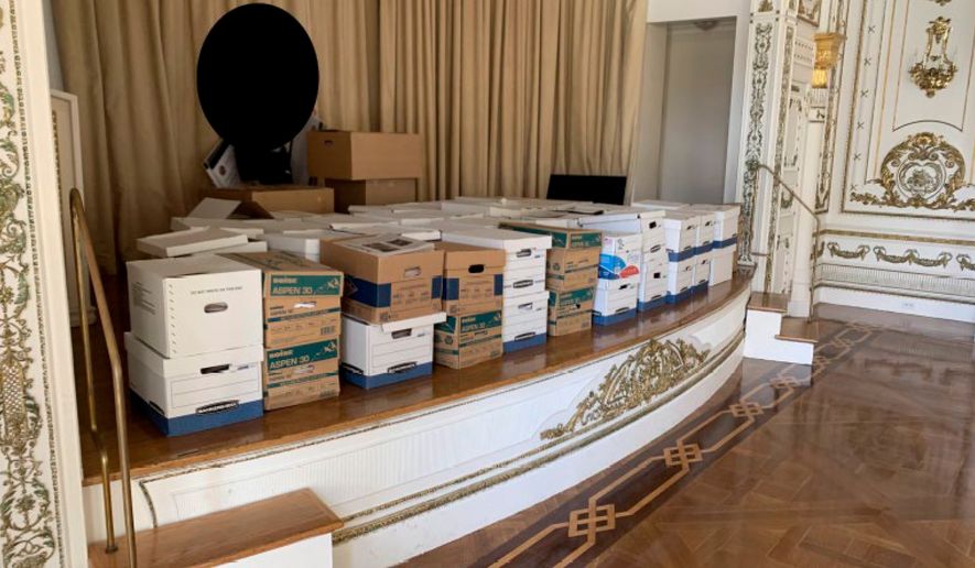 This image, contained in the indictment against former President Donald Trump, and partially redacted by source, shows boxes of records being stored on the stage in the White and Gold Ballroom at Trump's Mar-a-Lago estate in Palm Beach, Fla. (Justice Department via AP)