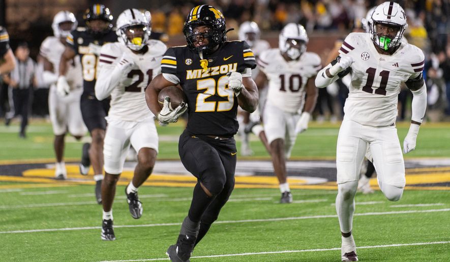 FILE - Missouri running back Ahmad Hardy (29) runs past Mississippi State linebacker Tyler Lockhart (11) and safety Hunter Washington (21) during the second half of an NCAA college football game Nov. 15, 2025, in Columbia, Mo. (AP Photo/L.G. Patterson, File)
