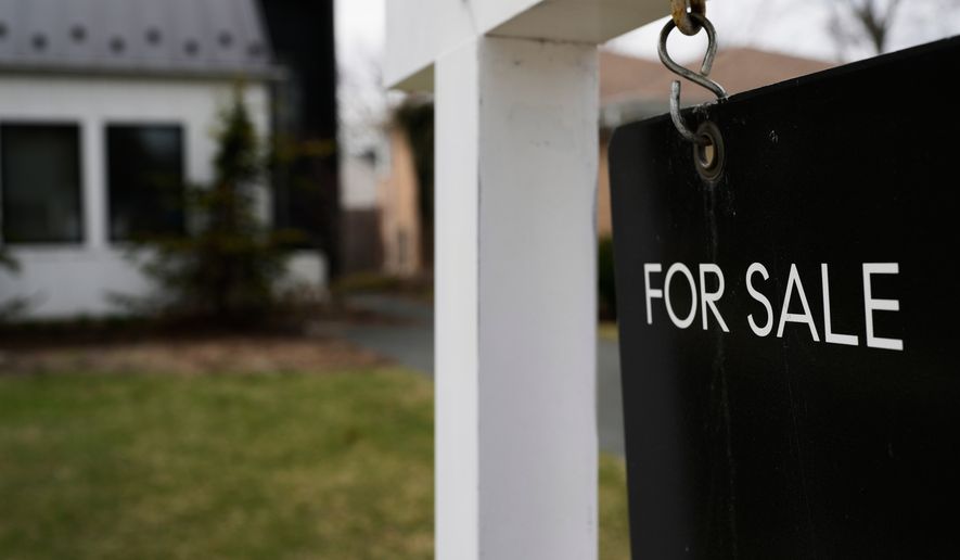 FILE - A for sale sign is displayed in front of a home in Evanston, Ill., on March 25, 2026. (AP Photo/Nam Y. Huh, File)
