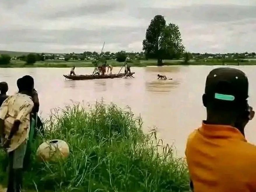 People gather at the site where a boat capsized in Sokoto, northwestern Nigeria, Thursday, Aug. 20, 2026. (AP Photo/Usman Yusuf)