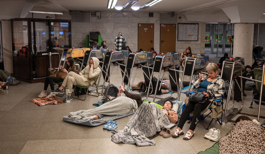 People take shelter in a metro station during a night Russian attack, in Kyiv, Ukraine, early Thursday, Aug. 20, 2026. (AP Photo/Danylo Antoniuk)