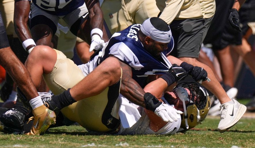 Dallas Cowboys outside linebacker Sam Williams, top, fight with New Orleans Saints tight end Moliki Matavao during an NFL football joint practice, Tuesday, Aug. 18, 2026, in Oxnard, Calif. (AP Photo/Mark J. Terrill)