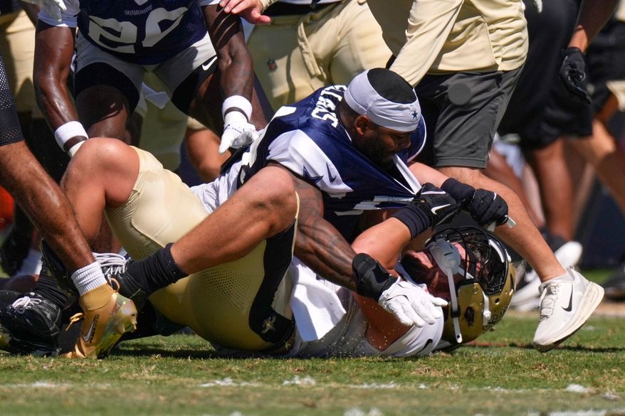 Dallas Cowboys outside linebacker Sam Williams, top, fight with New Orleans Saints tight end Moliki Matavao during an NFL football joint practice, Tuesday, Aug. 18, 2026, in Oxnard, Calif. (AP Photo/Mark J. Terrill)