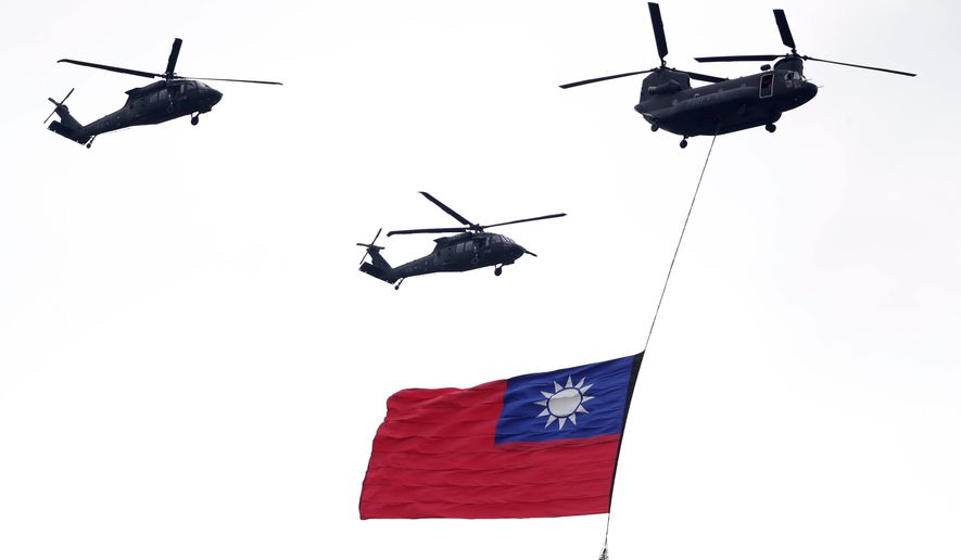 FILE - Helicopters fly over with Taiwan national flag during an inauguration celebration of Taiwan's President Lai Ching-te in Taipei, Taiwan, on May 20, 2024. (AP Photo/Chiang Ying-ying, File)