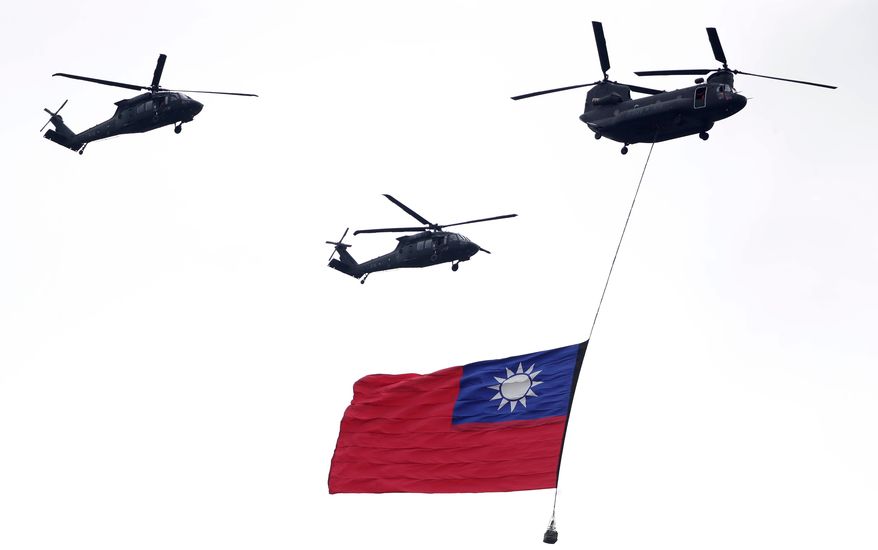 FILE - Helicopters fly over with Taiwan national flag during an inauguration celebration of Taiwan's President Lai Ching-te in Taipei, Taiwan, on May 20, 2024. (AP Photo/Chiang Ying-ying, File)