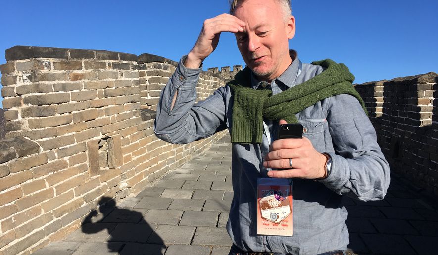 AP reporter Christopher Bodeen walks along the Mutianyu Great Wall section on the outskirts of Beijing, on Nov. 10, 2017, while covering Melania Trump’s visit to the wall. (AP Photo/Emily Wang)