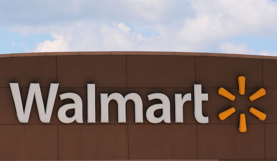 The Walmart logo is displayed on a store, Aug. 14, 2025, in Manchester, N.H. (AP Photo/Charles Krupa, File)