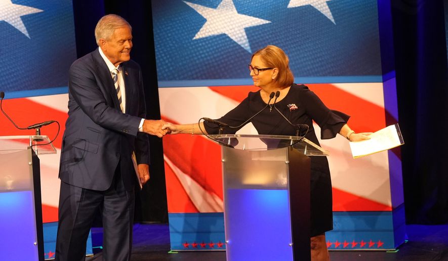 U.S. Rep. Ralph Norman, R-S.C., left, reaches over to shake hands with Sen. Darline Graham, R-S.C., during a debate ahead of the special GOP Senate runoff election to replace the late Sen. Lindsey Graham, R-S.C., in Newberry, S.C., Tuesday, Aug. 18, 2026. (AP Photo/Meg Kinnard)