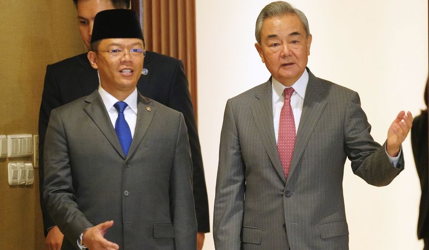 China's Foreign Minister Wang Yi, right, walks with his Indonesian counterpart Sugiono for the Comprehensive Strategic Dialogue between Indonesia and China in Jakarta, Indonesia, Friday, Aug. 21, 2026. (AP Photo/Tatan Syuflana)