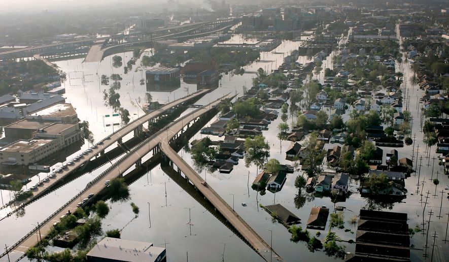 FILE - Floodwaters from Hurricane Katrina fill the streets near downtown New Orleans on Aug. 30, 2005. (AP Photo/David J. Phillip, File)