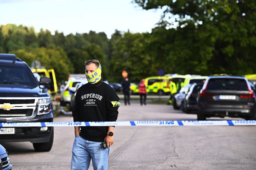 Police and emergency personnel outside Brinellskolan during a major emergency response after a man with a sword reportedly injured several people at the school in Fagersta, Sweden, Friday, Aug. 21, 2026. (Fredrik Sandberg/TT News Agency via AP)
