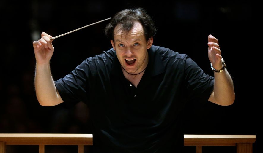 Boston Symphony Orchestra music director Andris Nelsons rehearses with the orchestra at Symphony Hall, Nov. 20, 2014, in Boston. (AP Photo/Steven Senne, File)