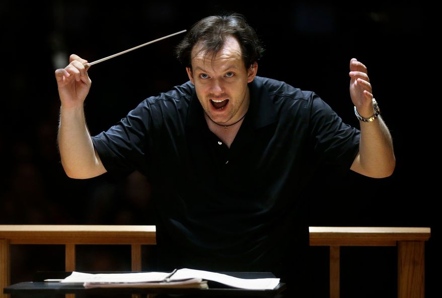 Boston Symphony Orchestra music director Andris Nelsons rehearses with the orchestra at Symphony Hall, Nov. 20, 2014, in Boston. (AP Photo/Steven Senne, File)