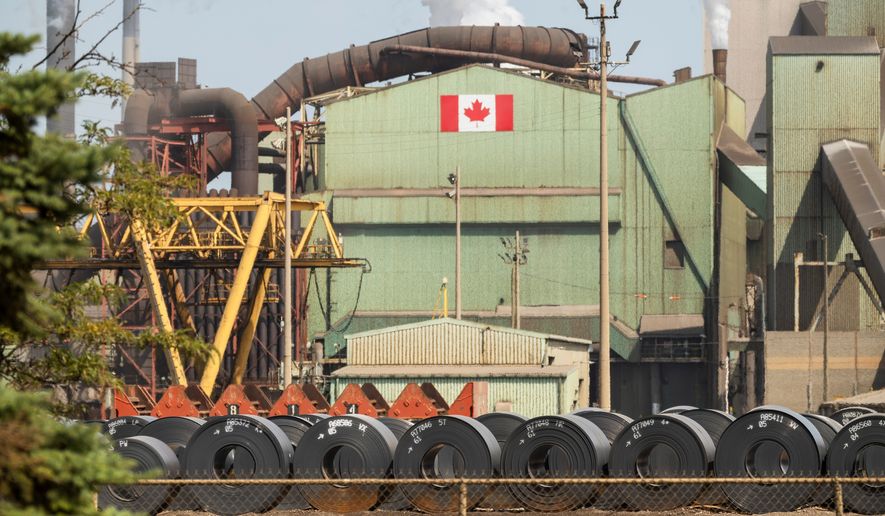 Rolled coils of steel sit in the yard at the ArcelorMittal Dofasco steel plant in Hamilton, Ont. on Thursday, Aug. 20, 2026. (Nick Iwanyshyn /The Canadian Press via AP)