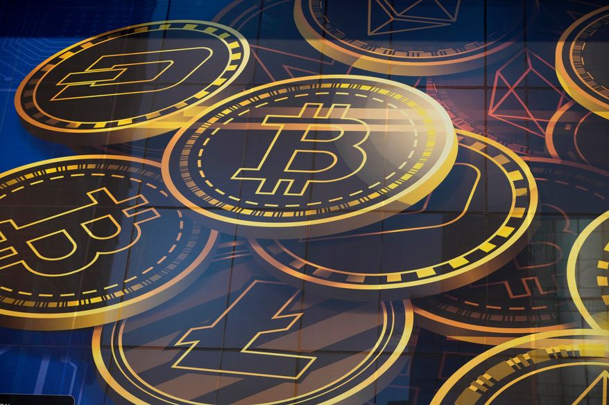 An advertisement for the cryptocurrency Bitcoin is displayed on a building in Hong Kong on Nov. 18, 2021. (AP Photo/Kin Cheung, File)