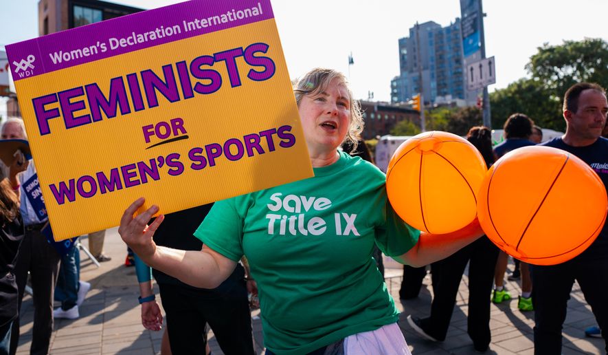Demonstrators rally against transgender athletes in women's sports outside of Barclay's Center before the WNBA basketball game between the Indiana Fever and the New York Liberty, Saturday, Aug. 22, 2026, in New York. (AP Photo/Angelina Katsanis)