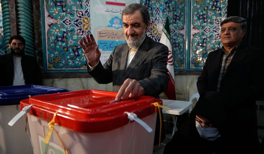 FILE - Former Revolutionary Guard commander Mohsen Rezaei casts his ballot during the parliamentary and Assembly of Experts elections at a polling station in Tehran, Iran, March 1, 2024. (AP Photo/Vahid Salemi, File)