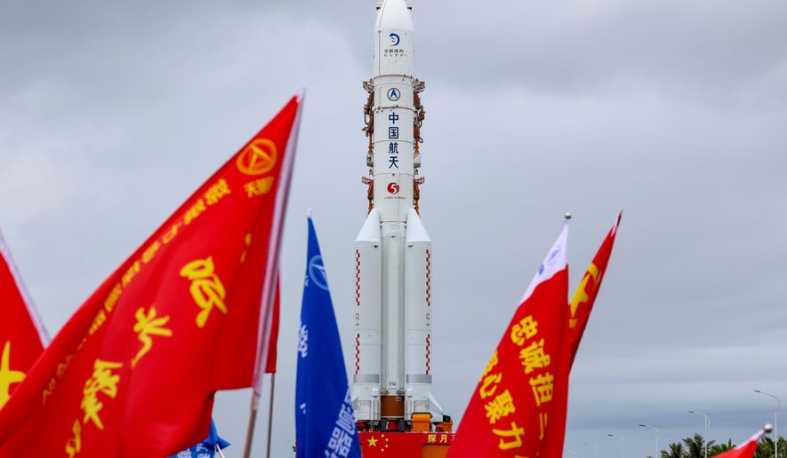 In this photo released by Xinhua News Agency, the combination of the Chang'e-7 lunar probe and the Long March-5 Y14 carrier rocket is transferred vertically to the launching area at the Wenchang Spacecraft Launch Site in southern China's Hainan Province on Wednesday, Aug. 19, 2026 . (Yang GuanyuXinhua via AP)