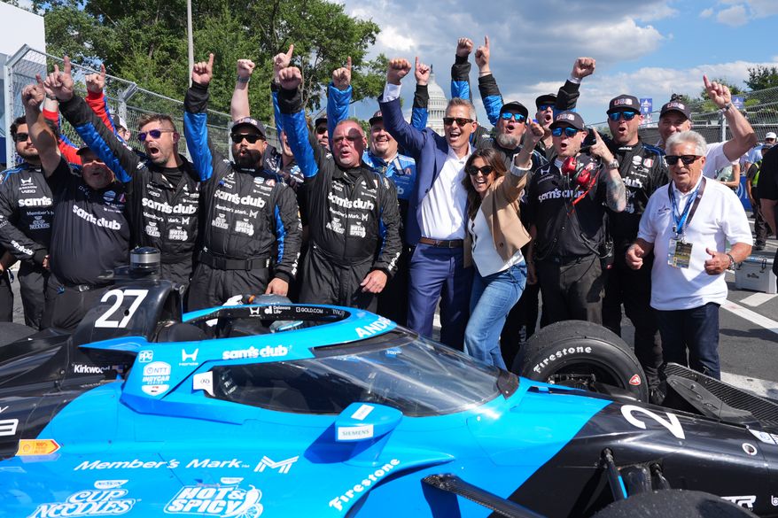 Transportation Secretary Sean Duffy joins for a photo after Kyle Kirkwood (27) won the IndyCar Freedom 250 Grand Prix auto race in Washington, Sunday, Aug. 23, 2026. (AP Photo/Alex Brandon)