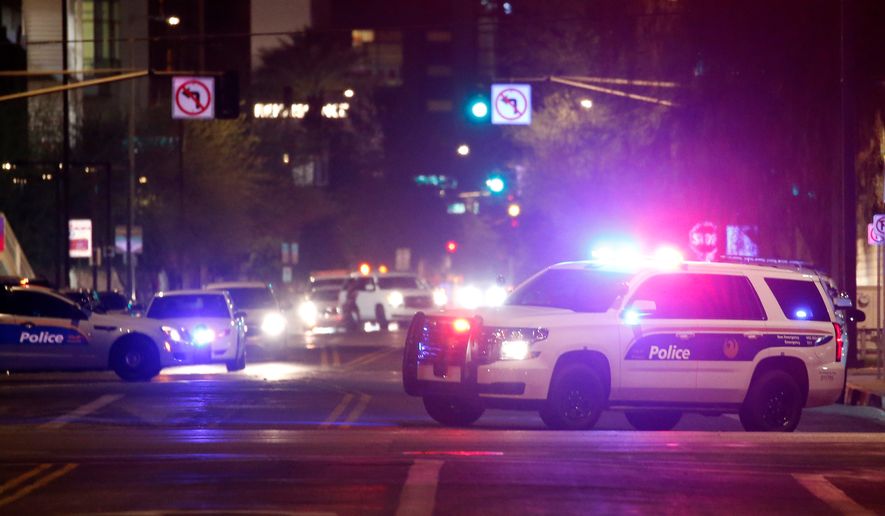 FILE - Phoenix Police Department vehicles block off a street in Phoenix, May 30, 2020. (AP Photo/Ross D. Franklin, File