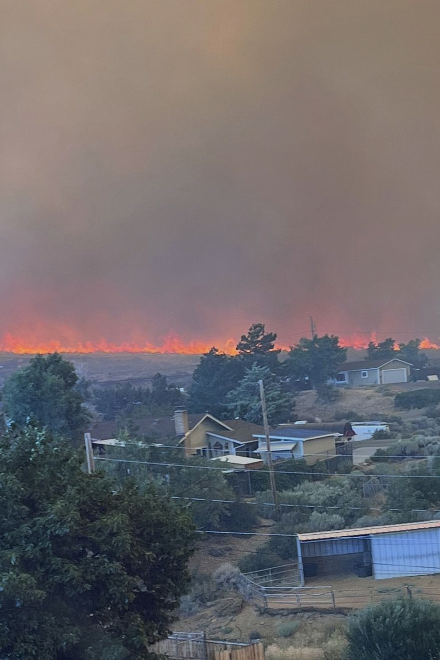 This image provided by Cari Kieffer shows part of the Hawk fire in Reno, Nev. (Cari Kieffer via AP)
