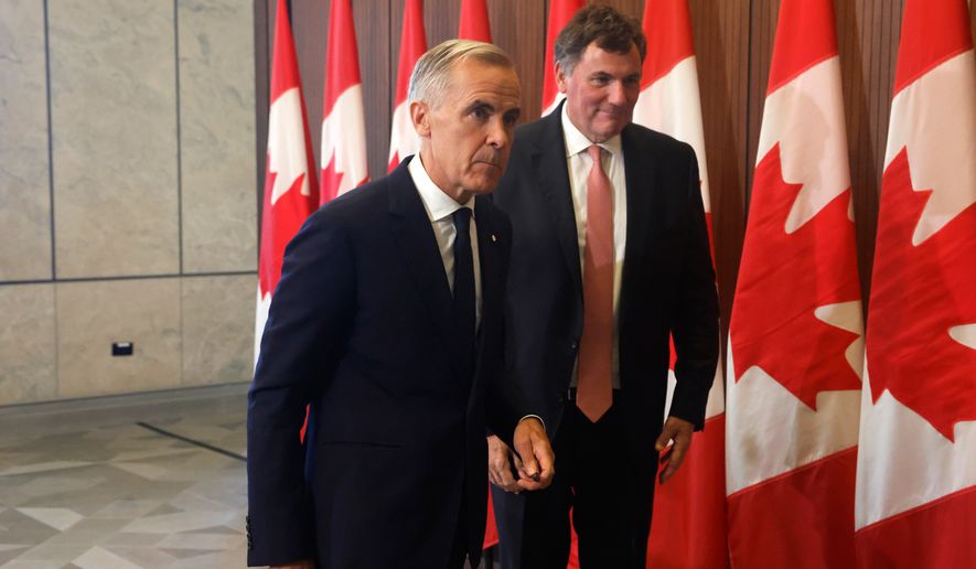 Prime Minister Mark Carney and Canada-U.S. Trade Minister Dominic LeBlanc leave a news conference about Canada's response to new U.S. tariffs on Parliament Hill in Ottawa on Saturday, Aug. 22, 2026. (Patrick Doyle/The Canadian Press via AP)