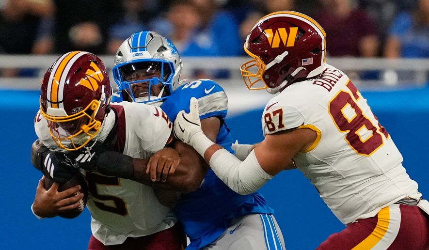 Detroit Lions defensive end D.J. Wonnum (98) sacks Washington Commanders quarterback Jayden Daniels (5) during a preseason NFL football game, Saturday, Aug. 22, 2026, in Detroit. (AP Photo/Paul Sancya)