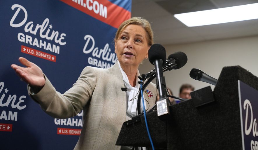 Sen. Darline Graham, R-S.C., gestures to Gov. Henry McMaster, R-S.C., at a news conference for her campaign a day ahead of the special GOP Senate runoff to replace her brother, the late Sen. Lindsey Graham, R-S.C., Monday, Aug. 24, 2026, in Columbia, S.C. (AP Photo/Meg Kinnard)