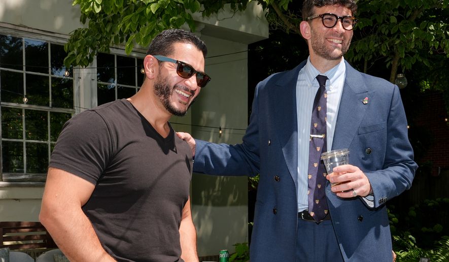 Abdul El-Sayed, a progressive candidate in the Democratic primary for U.S. Senate in Michigan, talks poolside with streamer Hasan Piker at a party for content creators supporting his campaign, Monday, Aug. 3, 2026, in Detroit. (AP Photo/Julia Demaree Nikhinson)