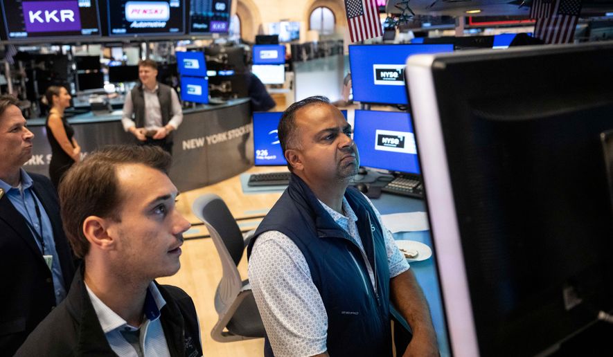 Specialists Dilip Patel, right, and Dylan Halvorsen work on the floor of the New York Stock Exchange in New York, Friday, Aug. 21, 2026. (AP Photo/Yuki Iwamura)