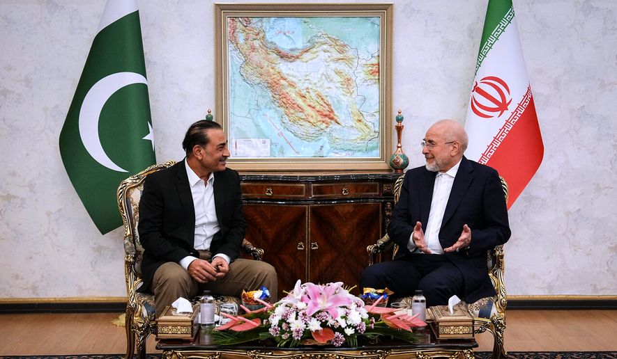 In this photo released by the Islamic Consultative Assembly News Agency, ICANA, Iran's Parliament Speaker and top negotiator Mohammad Bagher Qalibaf, right, speaks with Pakistan's Army Chief Field Marshal Gen. Asim Munir during their meeting in Tehran, Iran, Monday, Aug. 24, 2026. (Mahmoud Hosseini/ICANA via AP) ** FILE **