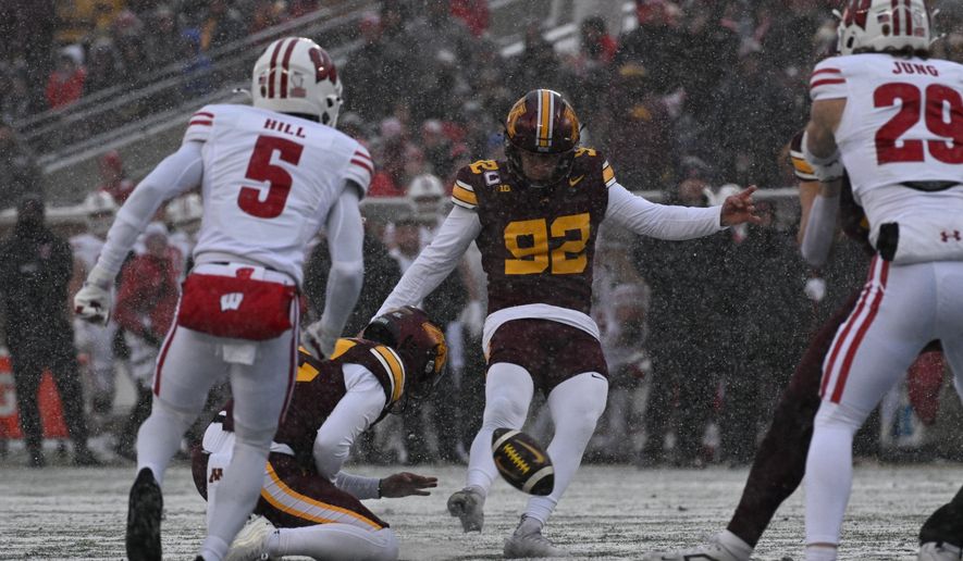 FILE - Minnesota kicker Brady Denaburg attempts a field goal during the first half of an NCAA college football game against Wisconsin Nov. 29, 2025, in Minneapolis. (AP Photo/Tom Baker, File)
