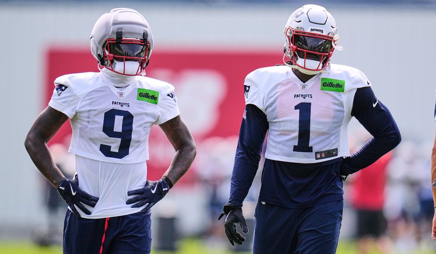 New England Patriots wide receivers A.J. Brown (1) and Kayshon Boutte (9) wait their turn on a drill during the team's NFL football training camp, Monday, Aug. 10, 2026, in Foxborough, Mass. (AP Photo/Charles Krupa)