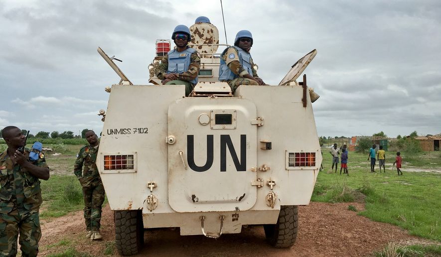 FILE - In this Sunday, June 18, 2017 file photo, peacekeepers from the United Nations Mission in South Sudan (UNMISS) provide security during a visit of UNCHR High Commissioner Filippo Grandi to the U.N. Protection of Civilians camp in Bentiu, South Sudan. (AP Photo/Sam Mednick, File)