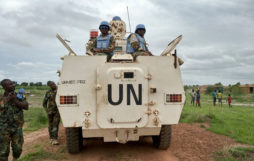 FILE - In this Sunday, June 18, 2017 file photo, peacekeepers from the United Nations Mission in South Sudan (UNMISS) provide security during a visit of UNCHR High Commissioner Filippo Grandi to the U.N. Protection of Civilians camp in Bentiu, South Sudan. (AP Photo/Sam Mednick, File)