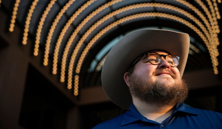 Giles Sims, who is getting a 90-hour bachelor of applied science in communication from Ensign College poses for a portrait on campus in Salt Lake City, Utah Thursday, Aug. 6, 2026, in Salt Lake City. (AP Photo/Marielle Scott)