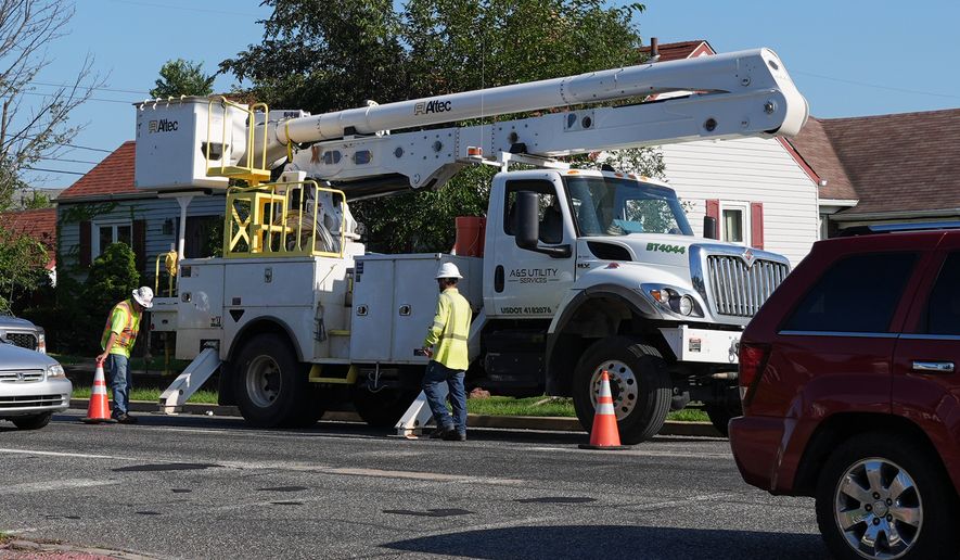 An electrical worker work power on the street for repair power in Gary, Ind, Thursday, Aug. 20, 2026, more than a week after a deadly storm passes through the area. (AP Photo/Nam Y. Huh)