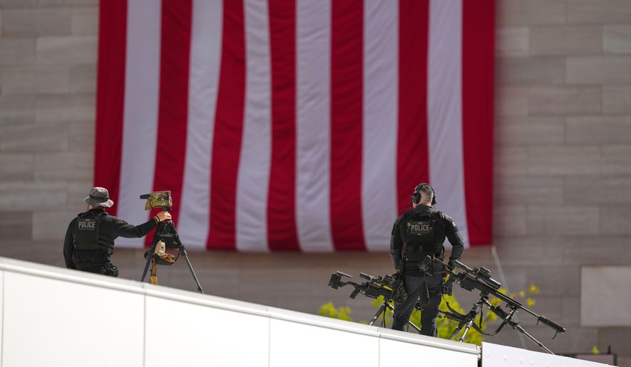 Members of the U.S. Secret Service police conduct overwatch during the IndyCar Freedom 250 Grand Prix auto race, Sunday, Aug. 23, 2026, in Washington. (AP Photo/Julia Demaree Nikhinson)