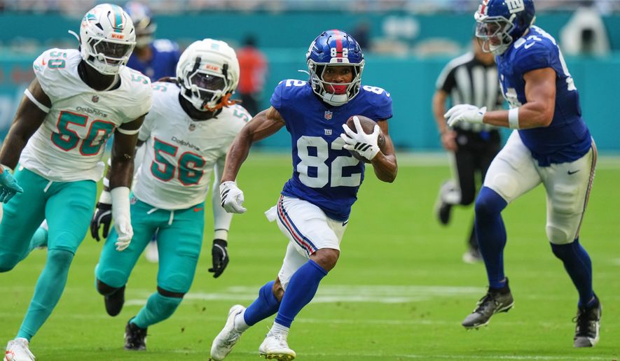 New York Giants wide receiver Calvin Austin III (82) runs the ball during the first half of a preseason NFL football game against the Miami Dolphins, Saturday, Aug. 22, 2026, in Miami Gardens, Fla. (AP Photo/Lynne Sladky)