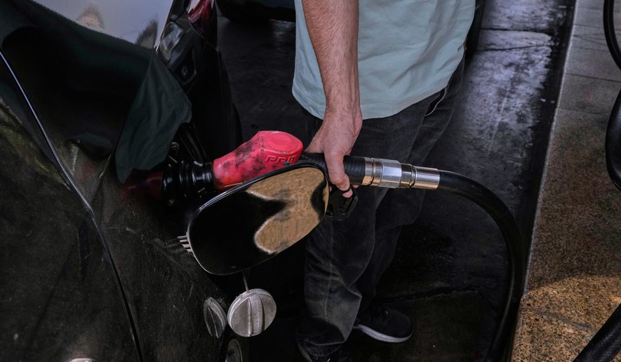 A man is filling up his car at a gas station in Tehran, Iran, Tuesday, Aug. 25, 2026. (AP Photo/Vahid Salemi)